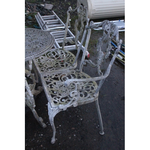 473 - Three piece cast metal garden table and chair set.