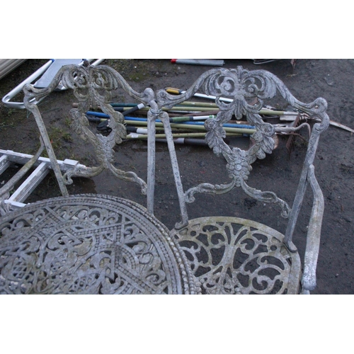 473 - Three piece cast metal garden table and chair set.