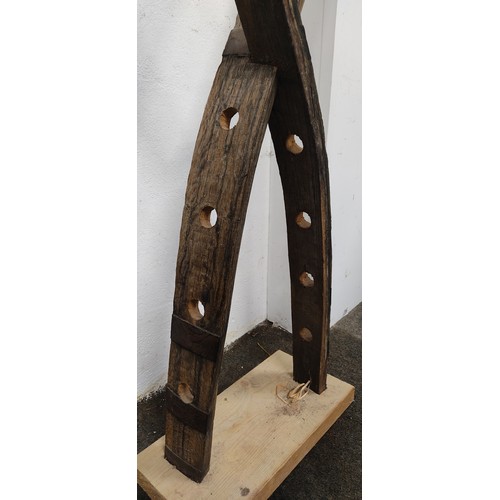 494 - An unusual wine bottle rack from whiskey barrel parts.