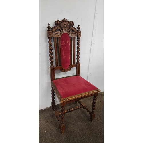 293 - An antique chair with intricate woodwork and lion motif designs.