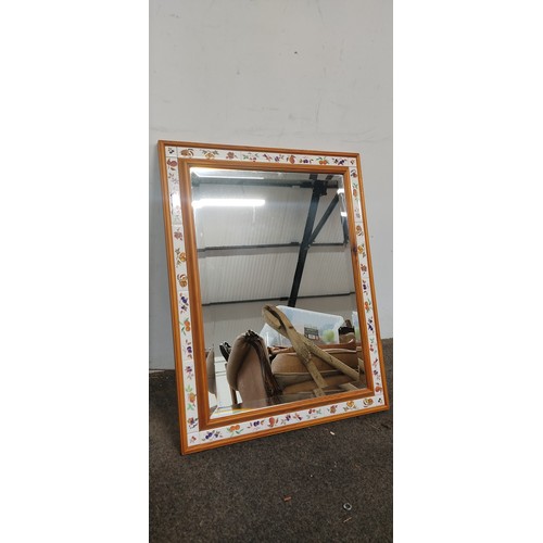 103 - A bevelled glass mirror with tile surround.