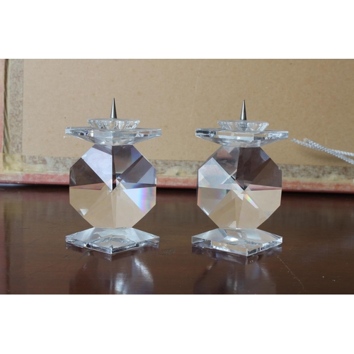 25 - A pair of Swarovski crystal candlesticks, measuring 8 1/2cm tall.