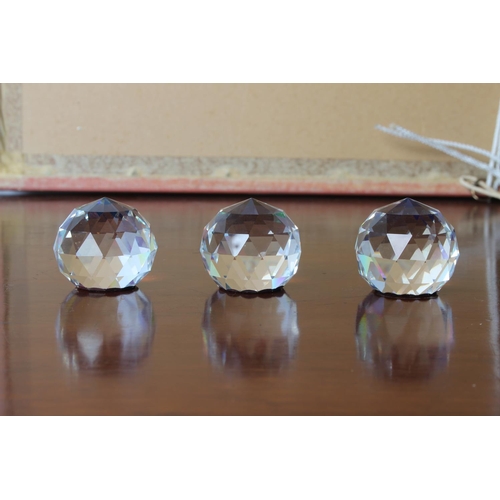 27 - Three crystal Vitrail rainbow faceted ball paperweights, measuring 4cm tall.