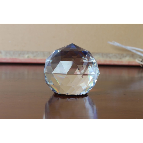 35 - A Swarovski crystal blue/purple faceted ball paperweight, measuring 5 1/2cm height.