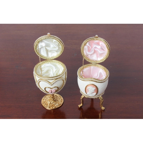 51 - Two Faberge style egg shaped trinket boxes.