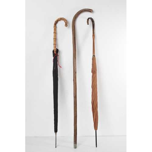 65 - Two vintage umbrellas and a walking stick.