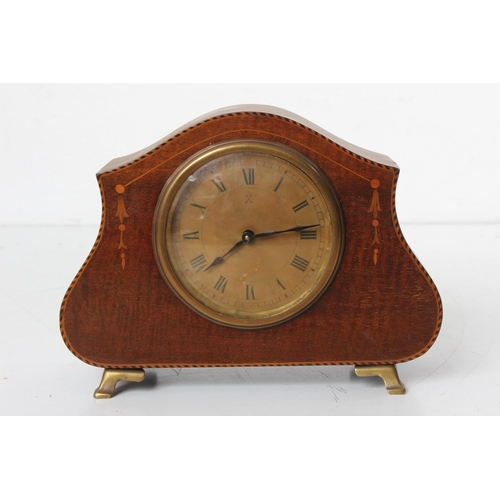 99 - An antique mahogany and inlay mantle clock on brass feet.