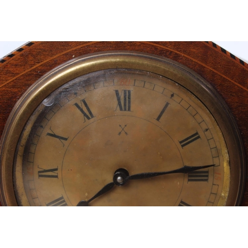 99 - An antique mahogany and inlay mantle clock on brass feet.