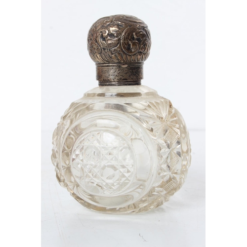 101 - An antique Sterling Silver topped perfume bottle.