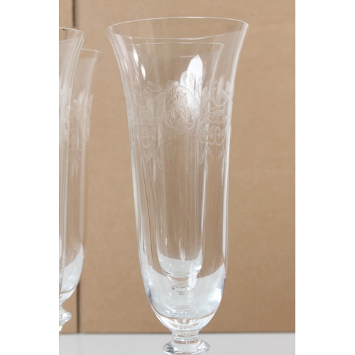 110 - A set of six vintage etched glass champagne flutes.