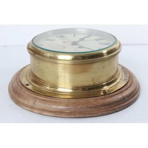 171 - A stunning antique brass cased Smiths Astral ships bulkhead clock, mounted on wooden base.