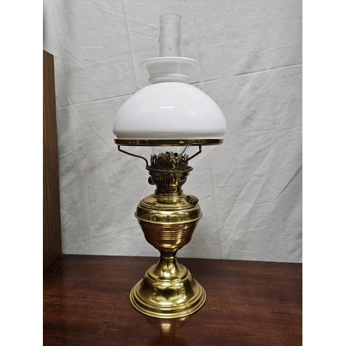 265 - A vintage oil lamp with brass base & milk glass shade.