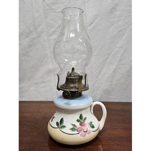 266 - A decorative antique finger oil lamp.