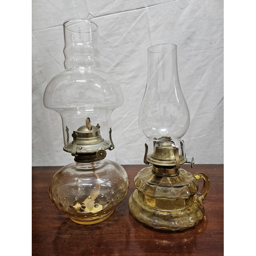 270 - 2 antique oil lamps with clear glass bases.