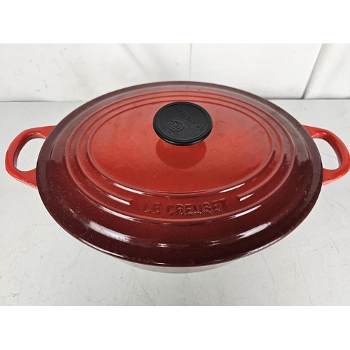 146 - A large red Le Crueset enamel pot, numbered 29 to base.