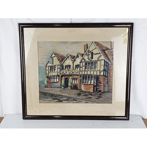 168 - A framed needlepoint tapestry of an English pub. 21.5 x 24.5 inch