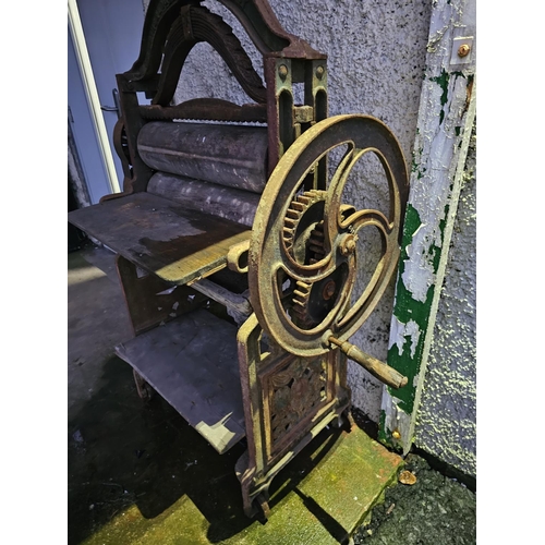 60 - An antique cast iron mangle, produced by Griffiths & Jones - Belfast, with decorative cast panels.