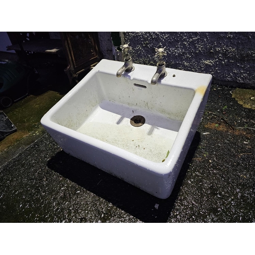 69 - A large antique Belfast sink, with taps.