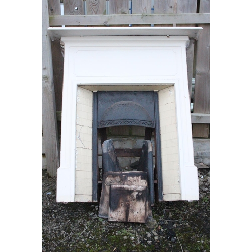 508 - An antique/ Victorian cast iron fireplace with tiled insert.