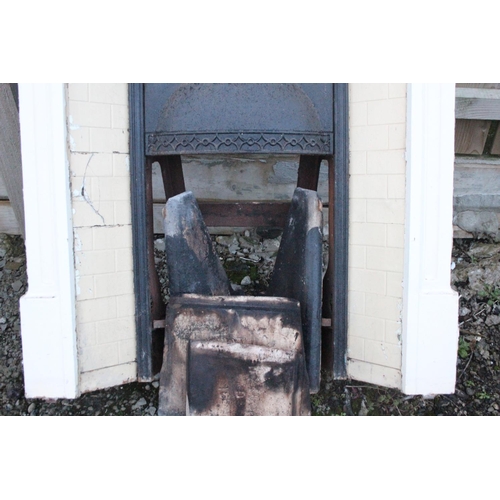 508 - An antique/ Victorian cast iron fireplace with tiled insert.