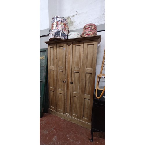 496 - A stunning Irish pine cabinet with folding doors, in need of light restoration. 49.5 x 80 inch