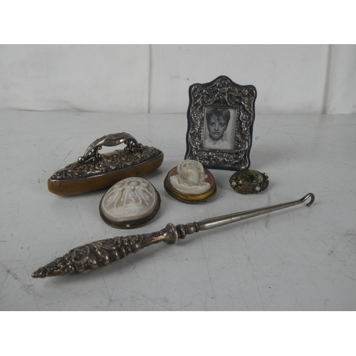 462 - An assortment of items, to include a silver button hook, vintage cameos and more.