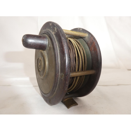 102 - An antique brass and rosewood fishing reel - R Lees, Perth.