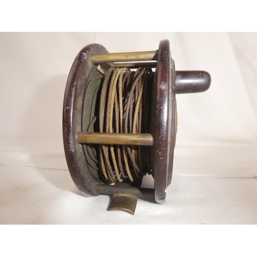 102 - An antique brass and rosewood fishing reel - R Lees, Perth.