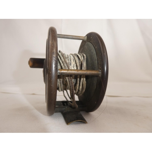 103 - An antique fishing reel.