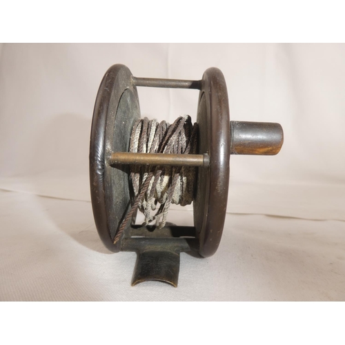 103 - An antique fishing reel.