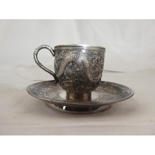 83 - A stunning antique Chinese Silver cup & saucer set, with decorative dragon design, weight 131g.