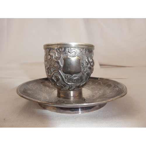 83 - A stunning antique Chinese Silver cup & saucer set, with decorative dragon design, weight 131g.