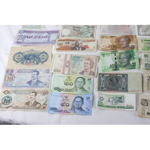 373 - A lot of assorted foreign bank notes from, Japan, South Africa, Germany, Bahamas, Cuba, Zimbabwe, Ho... 