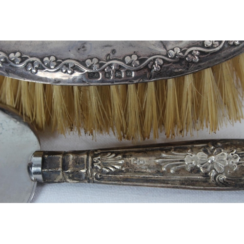 102 - A Sterling Silver backed hair brush and a Sterling Silver handled cake knife.