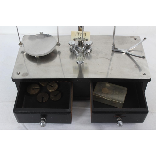 61 - A vintage CWS weighing scales mounted on a box with two drawers.