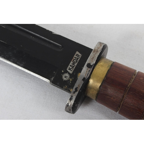 95 - A Kandar knife with wood and brass handle.