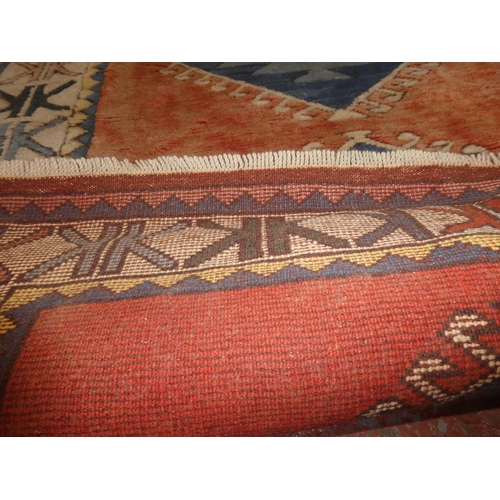 115 - A decorative rug, measuring 230cm x 145cm.