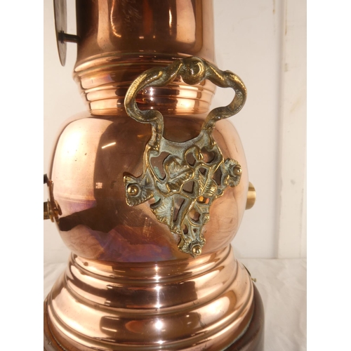 116 - A large 'Hot Irish Whiskey' copper samovar with decorative brass handles and tap, mounted on wooden ... 