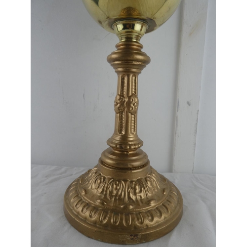 121 - A vintage brass oil lamp with gilt metal base, measuring 65cm tall.