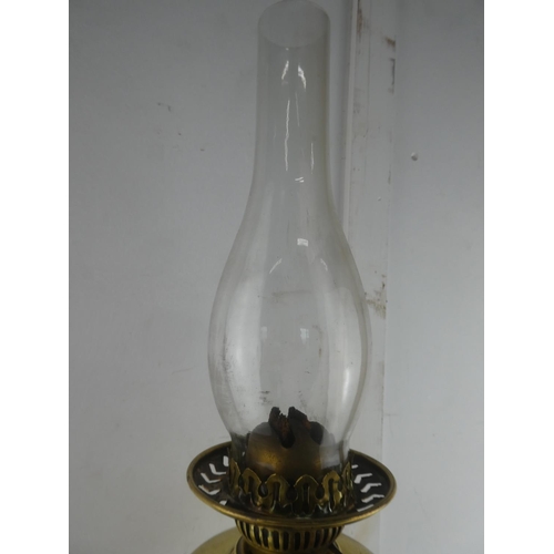 121 - A vintage brass oil lamp with gilt metal base, measuring 65cm tall.