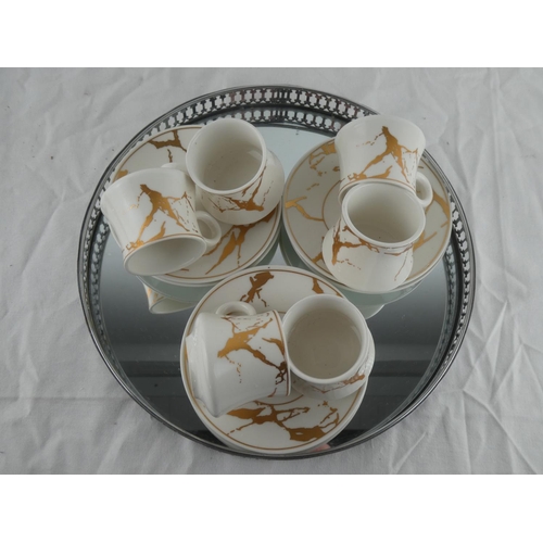 123 - An eight piece setting coffee set with gilt detail and a mirror gallery tray.