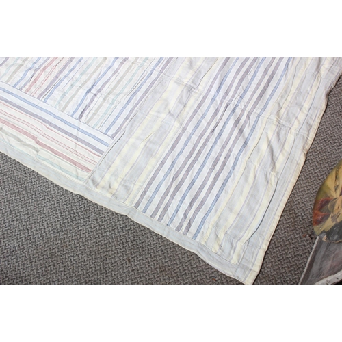 174 - An antique Irish handmade patchwork throw, double sided made from shirt material, measuring 208cm x ... 