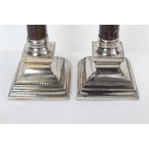 192 - A large par of silver plated candlesticks with metal columns, each measuring 38cm tall.