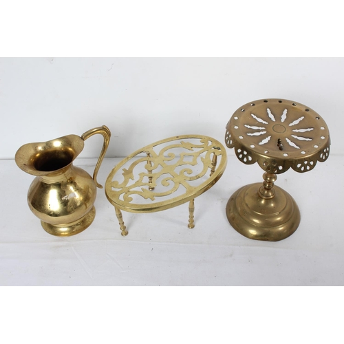 220 - An antique brass trivet, another brass pot/plant stand and a brass jug.