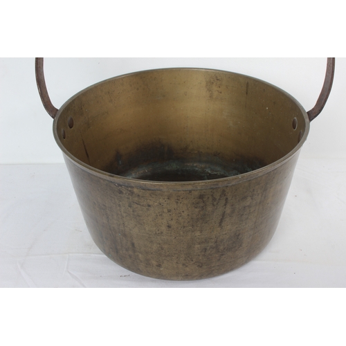 191 - A large antique brass preserving pan, measuring 34cm wide.