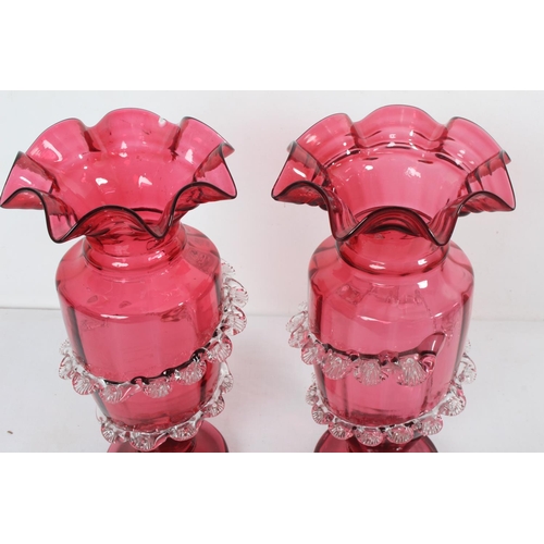 319 - A stunning pair of antique/ Victorian Ruby glass vases with decorative design, each measuring 27cm t... 