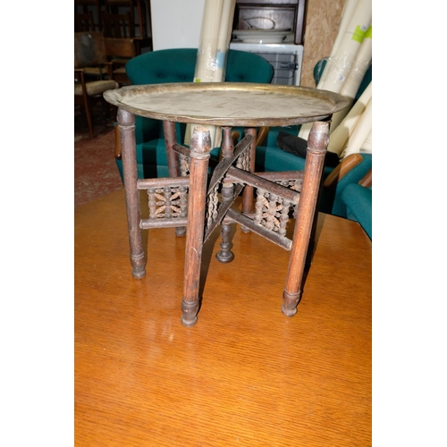 354 - A vintage folding table with brass tray top & carved base.