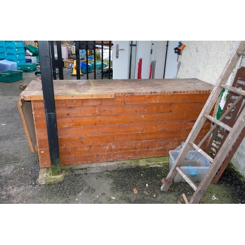 357 - A large vintage wooden workbench.