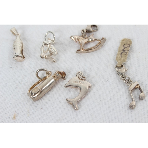 383 - A collection of 6 sterling silver charms to include Coca Cola bottle & more.