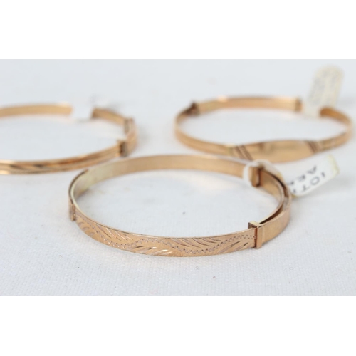 384 - 3 rolled gold baby bangles.